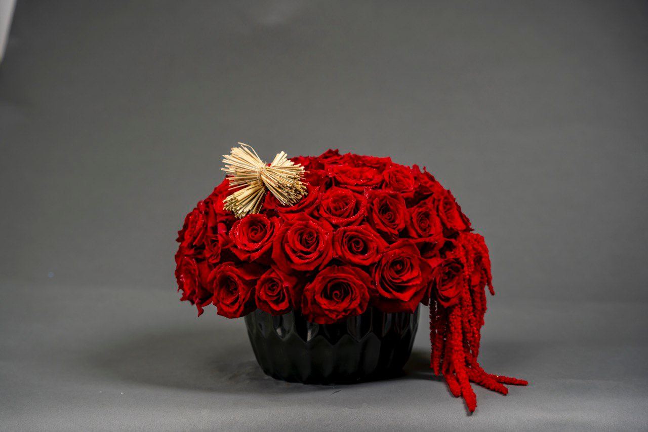 Red roses in black vase